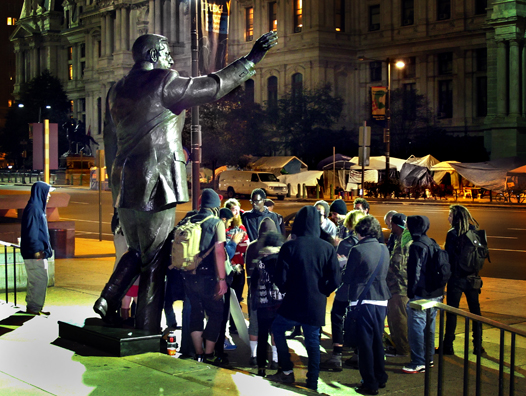 Occupiers discuss their occupation under the statue of Frank Rizzo across from Philadelphia City Hall (John Grant)
